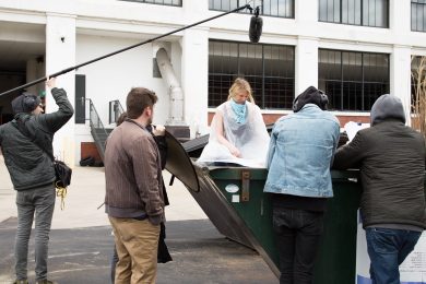Staley on location acting in a dumpster